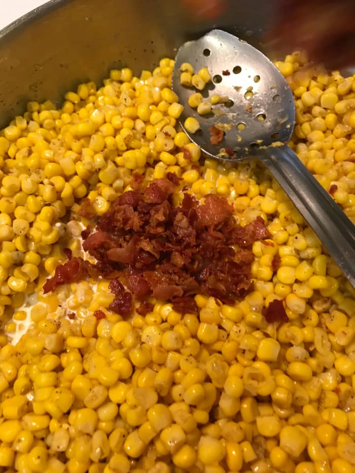 A little kosher salt and pepper are really all this dish needs. Black pepper is gorgeous with the bright flavor of the corn, and you're really only heating the corn through. Add the bacon back to the pan.