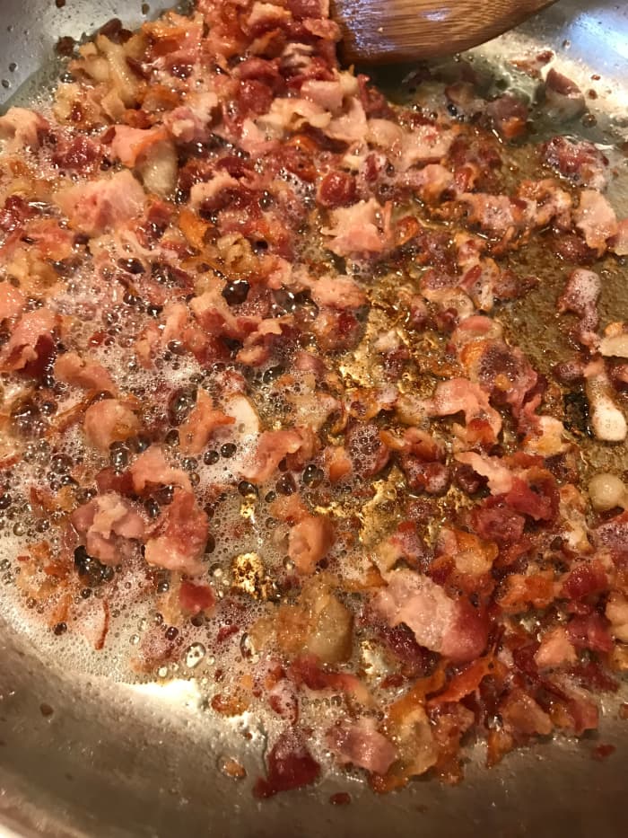 I have discovered that the best way to get super crispy bacon (and to get the maximum amount of grease out) is to cook the bacon slowly on medium low heat. This renders out as much of the fat as possible, producing the best smoky bacon flavor.