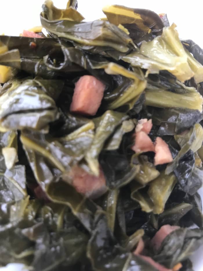 Rich and delicious, southern style collard greens are loaded with nutrients and fiber. Serve with creamy grits or cast iron skillet cornbread for a perfect meal.