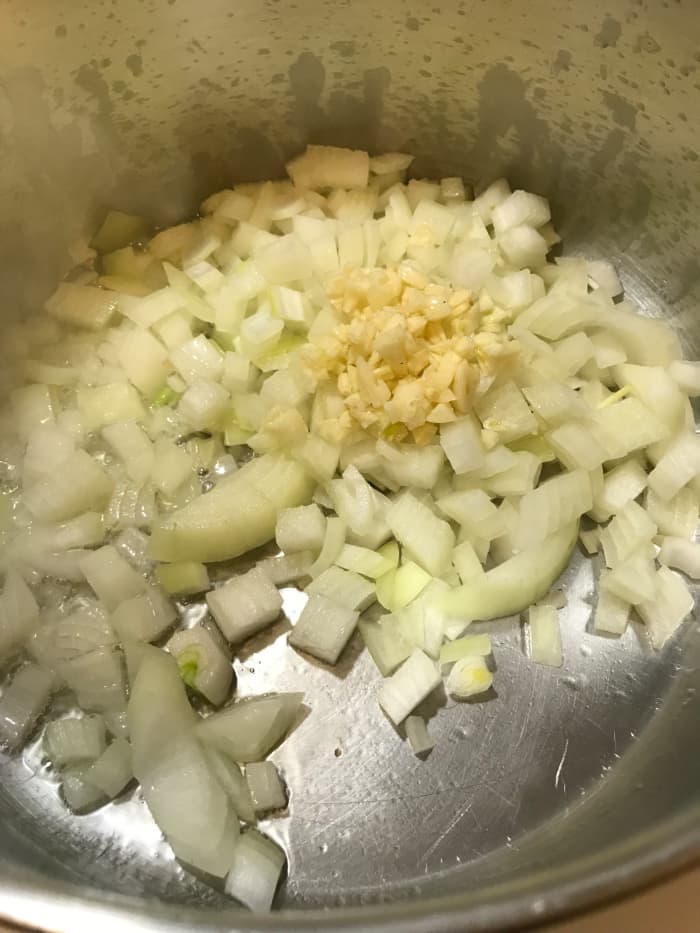 Saute the onion and garlic in the olive oil for about 10 minutes, or until they are softened and fragrant.