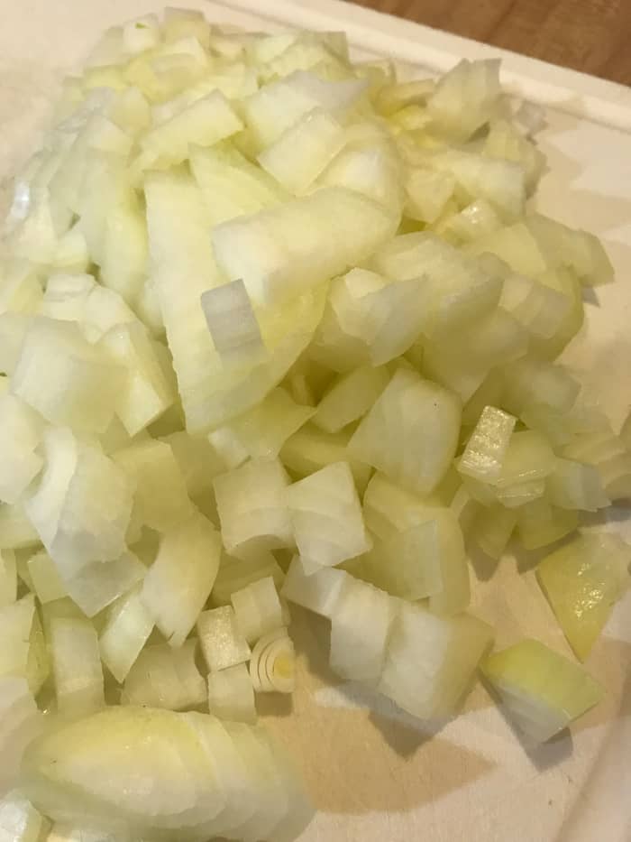 Start by dicing one large onion. I use yellow or white onions. The long cooking time leaves them mellow and sweet. Sweet onions like Vidalias or Walla Walla onions don't have enough 'punch' for long cooking times.