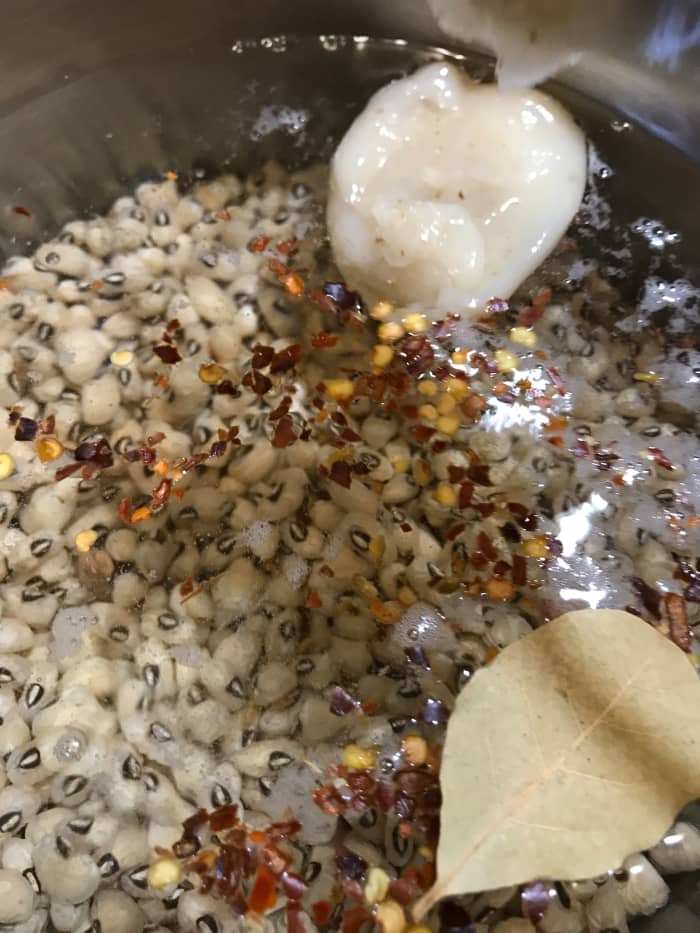 Add the remaining seasonings and bring to a simmer. You can skip the bacon drippings to have a vegan version, but you'll need to increase the salt and pepper, and maybe add a drop of liquid smoke. The bacon grease is the traditional method.