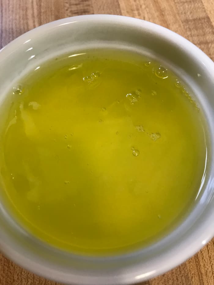 Separate four eggs, and place the whites in the bowl of a mixer. These will make the eggnog light and fluffy. The yolks will be cooked with sugar, milk and cream to form the base of the eggnog.
