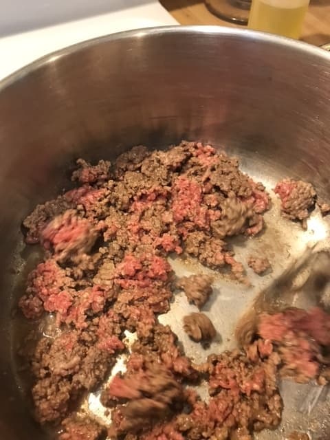 Cook the ground beef over medium heat, stirring frequently to crumble into small pieces. Cook until no more pink is visible, about 7-10 minutes. Drain excess grease and it's ready for the vegetables.