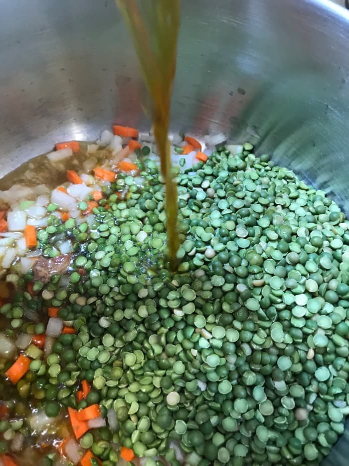 Add one pound of dried green split peas. They're sold both in bulk in most grocery stores, or in one pound packages with the dried beans and rice. If you look, you can find them for as little as .69 a pound, making this dish incredibly economical.