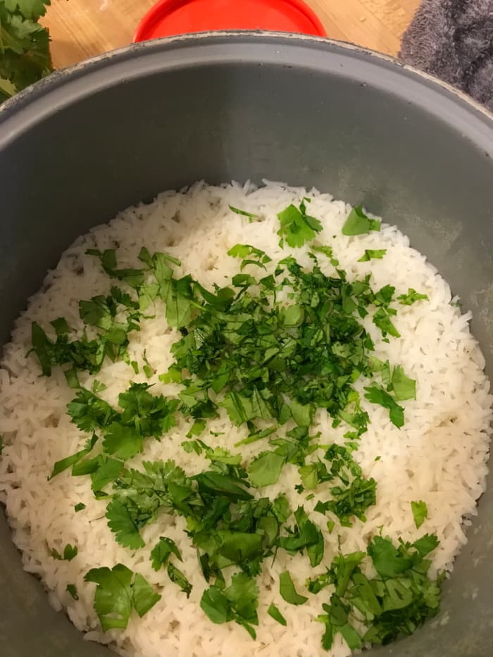 Mince the cilantro at the last minute - cilantro tends to get wilted and will turn black if you cut it and let it sit. It only takes a few seconds to mince, so just be patient. Once the rice is ready, mince and toss it with the rice.