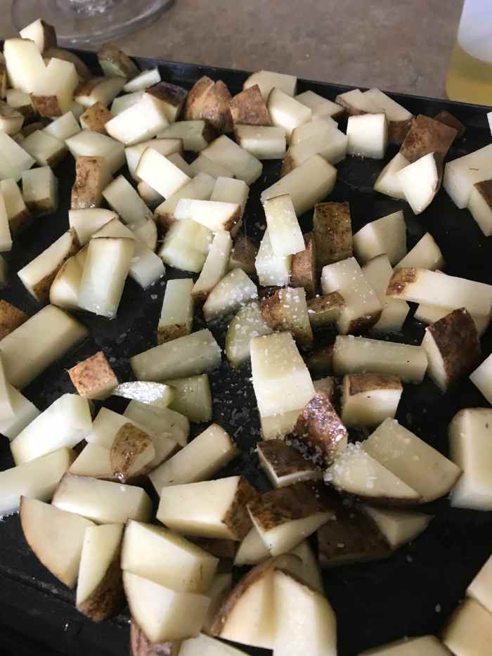 Heat your pan (or griddle like I have) to medium heat, and add a little olive oil. You don't want the potatoes greasy or oily, but you do want enough to coat the exteriors and ensure you get crispy, golden perfection.