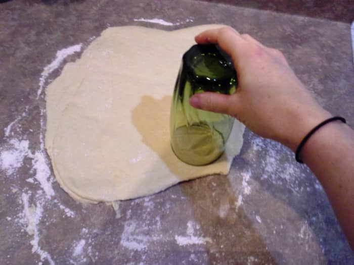 With a glass that will give you the size biscuit you are looking for, cut out your biscuits.