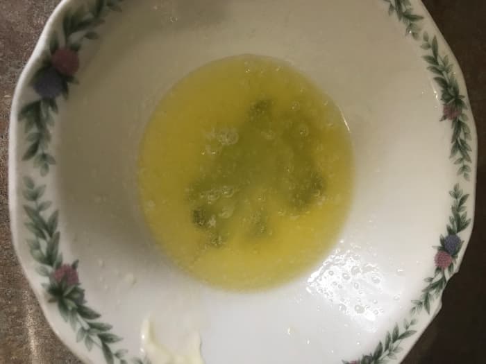 Zap the butter in the microwave for just a few seconds to melt it completely. This makes tossing with the cracker crumbs much easier.