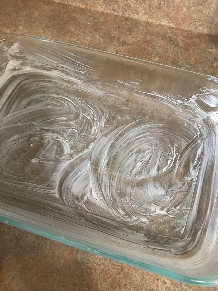 Use a 7x11 casserole dish. Be generous when rubbing it with butter - not only does the flavor enhance the finished dish, but it seriously prevents sticking - the sugary base can stick hard!