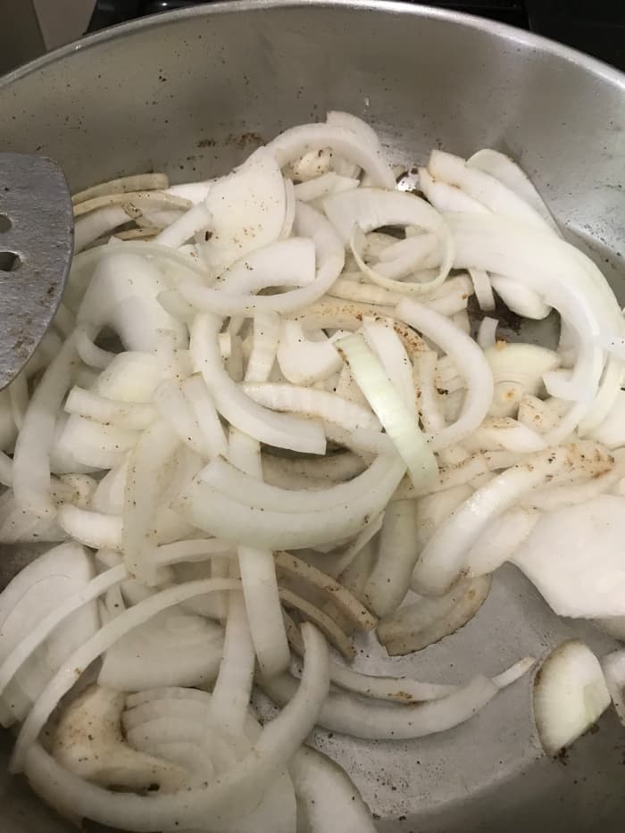 You don't have to use onions - I don't think I did in the video below. But they add a great flavor to the gravy. Start by cooking the onions in the same skillet as the steaks until they soften and become fragrant, about ten minutes.
