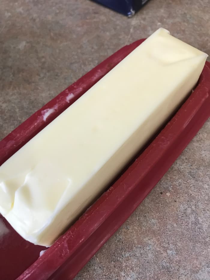 Use both types of fat for the best result. Butter is used for flavor, but will burn in the extended heat needed to brown the steaks. The addition of olive oil will raise the smoke point of the butter, so you get the best of both worlds.