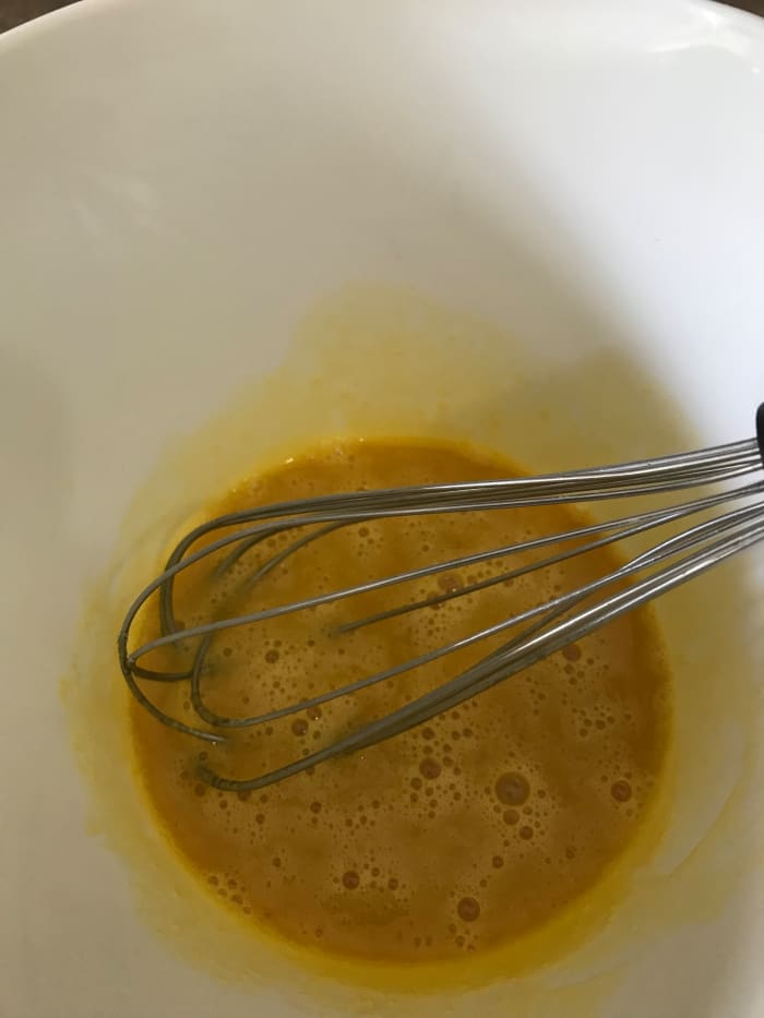 Whisk egg yolks with vanilla and salt before tempering the egg yolks with the hot half and half/cocoa mixture.
