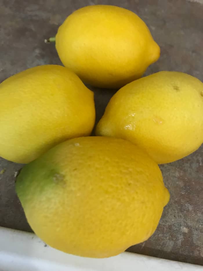 You need about 2 tablespoons of fresh lemon zest; it usually takes just at 2 fresh lemons worth of zest. I think the easiest way is to zest two lemons first, then squeeze them once you know how many you'll need to zest for the 2 tablespoons.