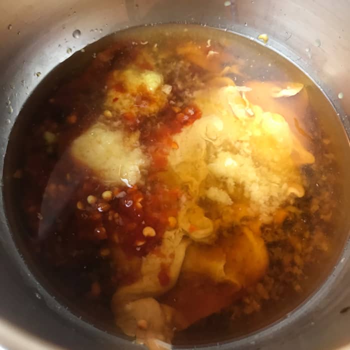 Combine all of the dressing ingredients together in a bowl, and whisk them together to create your creamy dressing.