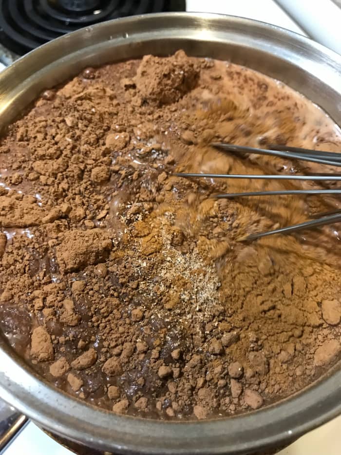 Most of the cocoa lumps will just dissolve as the milk warms. If you find one, squash it with the back of a spoon against the side of the pan.This is lazy, easy cooking.