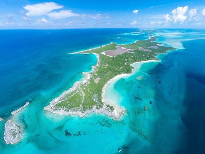 The Cays between the United States, the Bahamas, and Cuba might be beautiful, but I have huge doubts about whether they would be sufficient for water and shelter for an isolated girl sustained only by dolphins.
