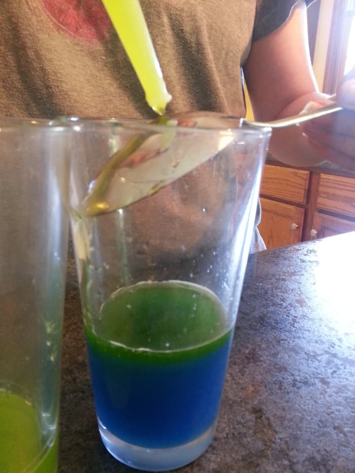 You must slowly drip the sugar/water solution for each layer. When you do the varying densities of the water will cause them to separate.