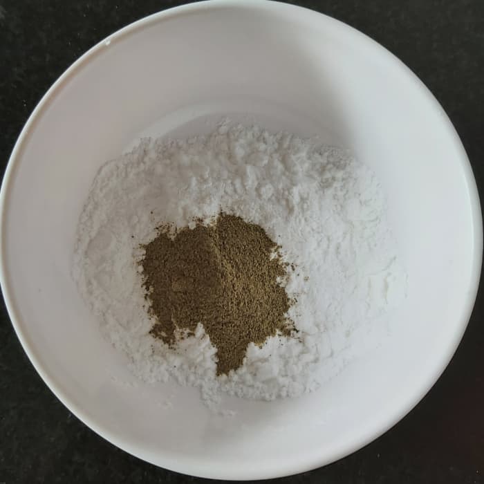 Meanwhile, in a bowl, take 2 tablespoons of corn flour and 1 teaspoon of pepper powder (can use black or white pepper powder).