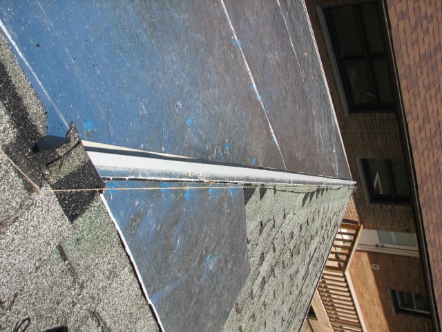 the reverse J Trim is run on top of the foil covered foam sheeting...this is where the ridge cap will be anchored when the steel roofing panels are all in place