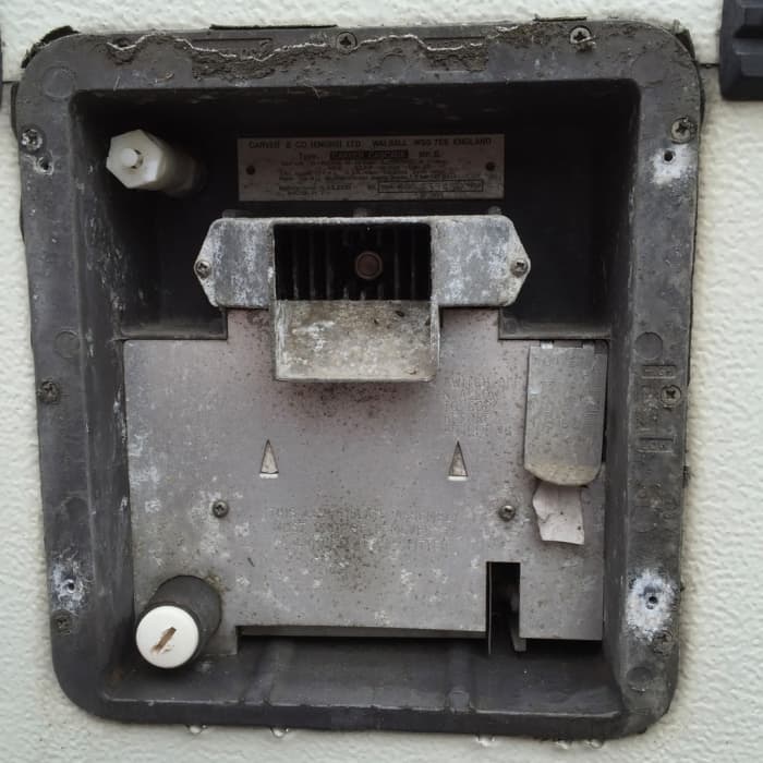 This shows what is immediately behind the flue cowl. At the bottom left corner you can see the drain plug that has to be undone.