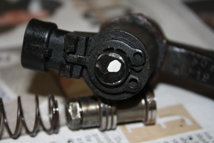 This is the top of the EVO valve showing the spring clip (electrical connector to the left). If the fluid was burnt or dirty, remove the clip and clean the valve inside, otherwise don't disassemble this valve.