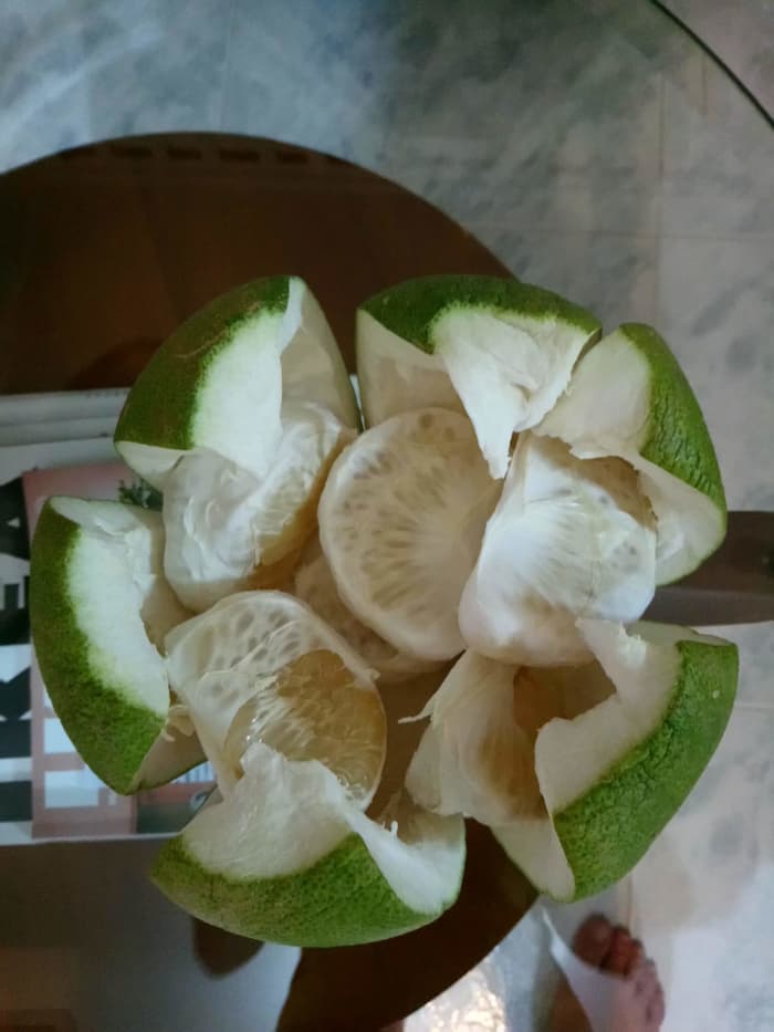 Pomelos are sweet, nice and fragrant. They are covered with a thick layer of skin that needs to be peeled off before you can eat them.