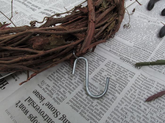 Metal hook that came already inserted into the grapevine. I could then attach my 'S' hook to that for easy hanging.