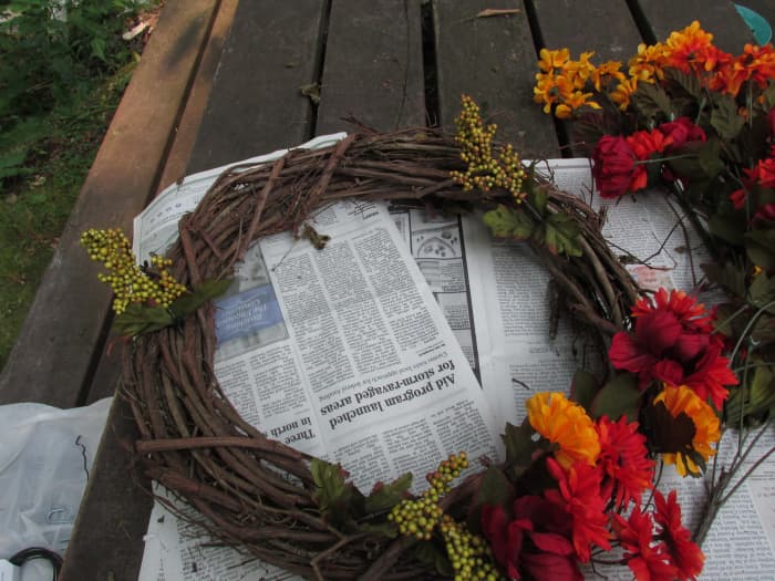 Begin by adding flowers starting with your focal point. I had some interesting green berry stems that I used for dividing my wreath into thirds.