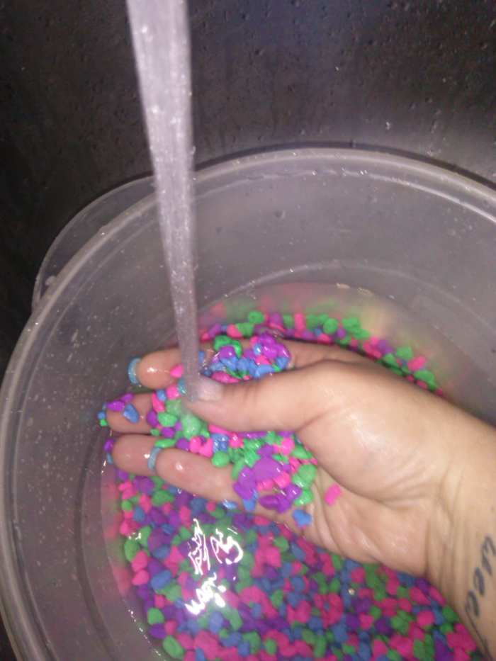 Rinse away debris from the pebbles.