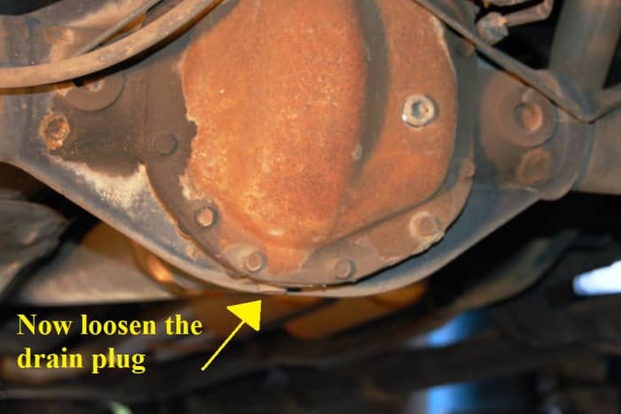Be sure to position you drain pan directly underneath the plug. With the 3/8" ratchet, remove the lower drain plug.