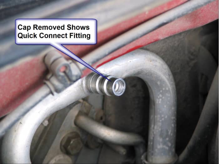 Cap of low pressure service port has been removed, revealing threads for the quick connect hose.