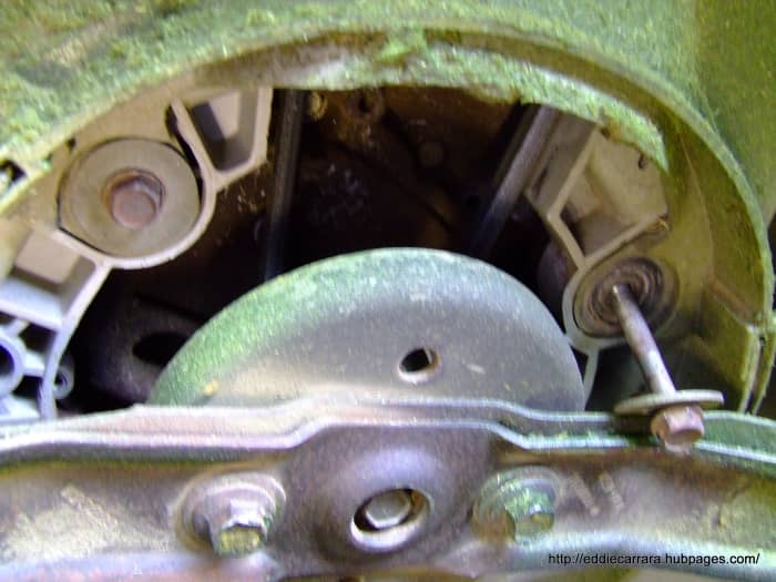 Remove the engine bolts that hold the deck cover on from underneath the Honda Harmony 215