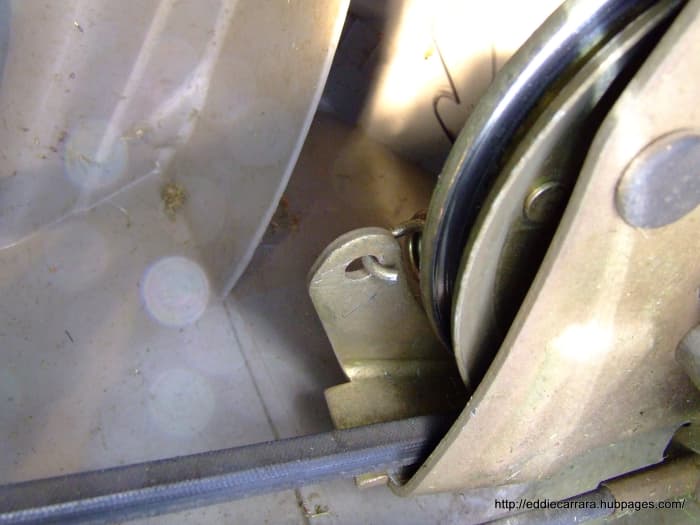 Once the drive belt is off, the spring is easy to remove. To re install the spring, put the spring on first and use the channel lock pliers to twist the trans and slip the drive belt back on the pulley on the Honda Harmony 215