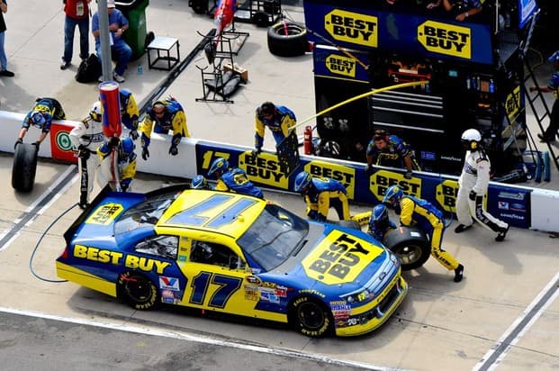 The #17 Best Buy car receives service in its pit stall. Notice the painted lines in front and behind the car, representing the edge of the stall