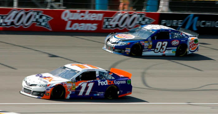Different cars choose to run different lines on the track. Here, #93 runs the outside line while #11 runs the inside line