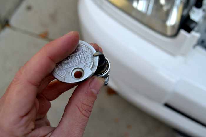 Reading the gap measurement on the plug. The gap should be .032 inches. Check your owners manual for your exact gap spec.