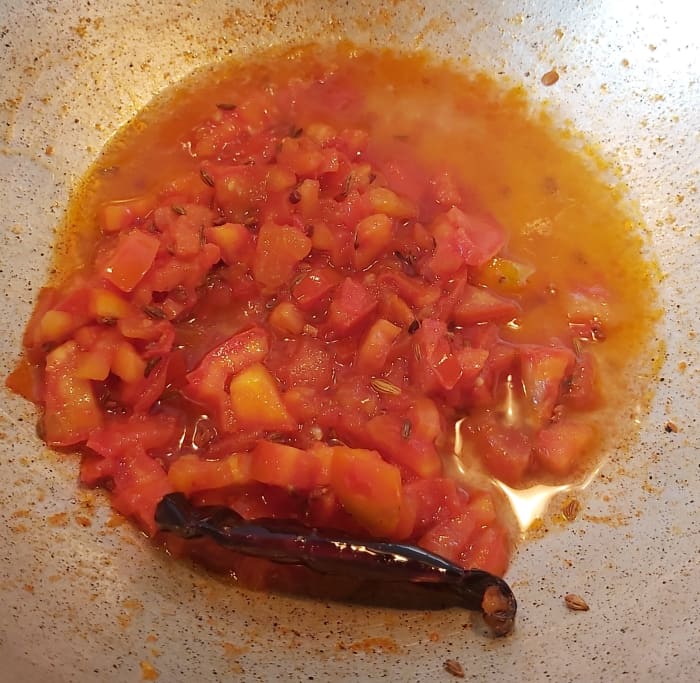 Add about 1/2 cup of water and continue to cook over low heat till the tomatoes cook properly. Stir in between to prevent sticking to the bottom.