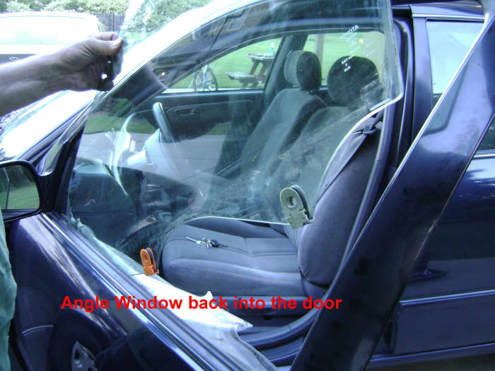 f(3). Angle the door window into the door. A helper can help position the door glass. Then screw on the door glass mounting bolts.