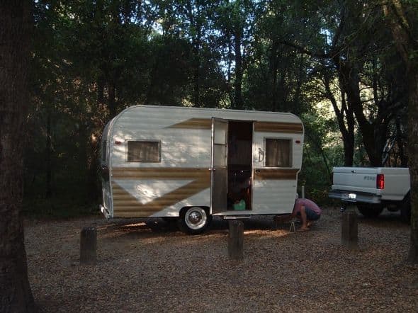 My 1959 Dalton in the woods at the Henry Cowell Redwood State Park near Santa Cruz, CA. Here, Mr. Wonderful is adding the jacks to the front to level it.