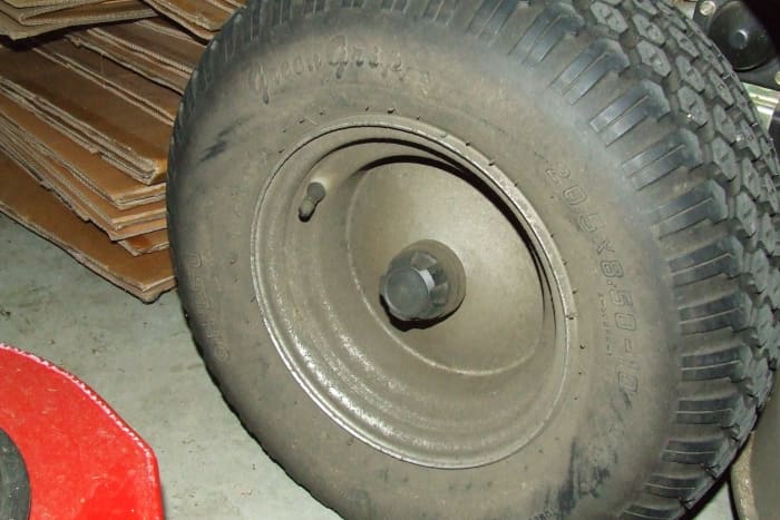 Leaking axle seal on a Honda tractor. Dirt sticking to the differential fluid all over the outside of the wheel is a sure sign of an axle seal leak.