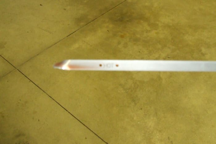 Honda transmission fluid. The end of the transmission fluid dip stick. Notice that the fluid is red.