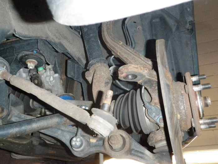Disconnect the tie rod end, lower, and upper ball joints from the knuckle assembly.