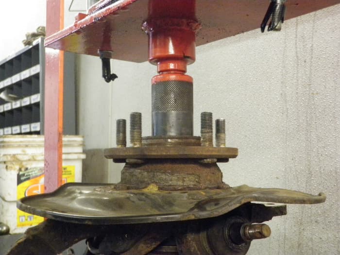 Once the bearing is installed and the snap ring is in place, support the bearing from the bottom and press the hub into the center of the bearing, be sure to support the center race from the bottom or you will separate the bearing resulting in damage