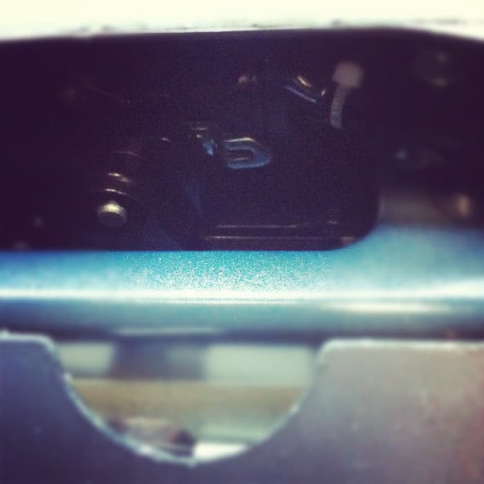 Pull that silver, backward c-shaped lever toward you. The trunk door will pop open.