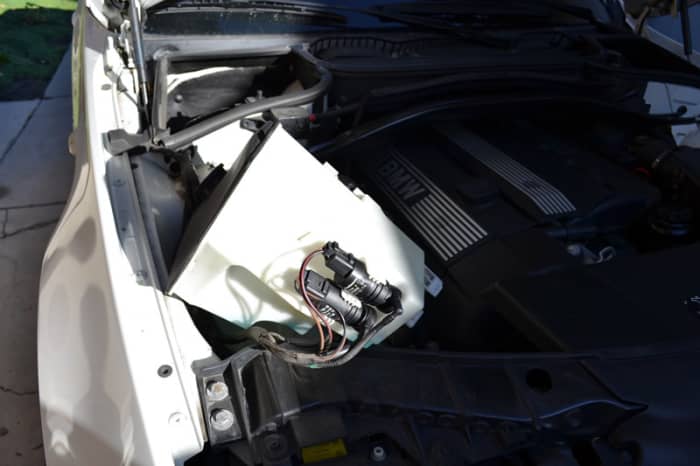 Once the bolt is removed, pull the basin out and tilt it upward so the remaining fluid won't leak when you pull out the pump. This assumes MOST of the fluid has already leaked out and only a little remains in the very bottom.