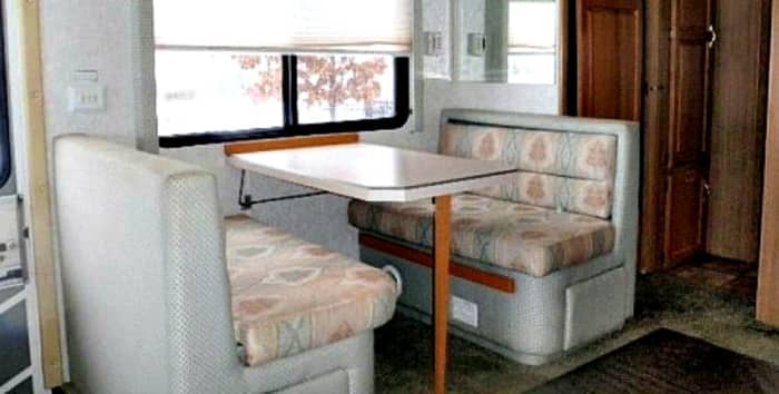 This comfortable eating booth has storage below each seat and can be converted into a bed.