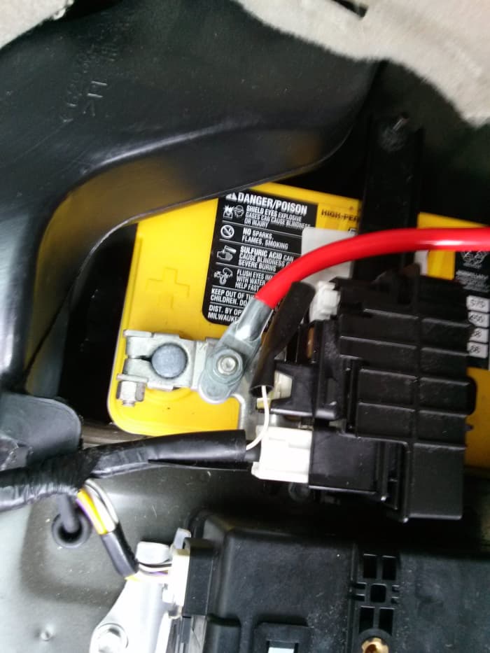 Remove the bolt beside the positive terminal clamp, attach the positive power cable and tighten the bolt on top of it.
