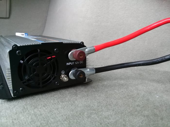 Securely attach the power cables to their appropriate post on the rear of the inverter.