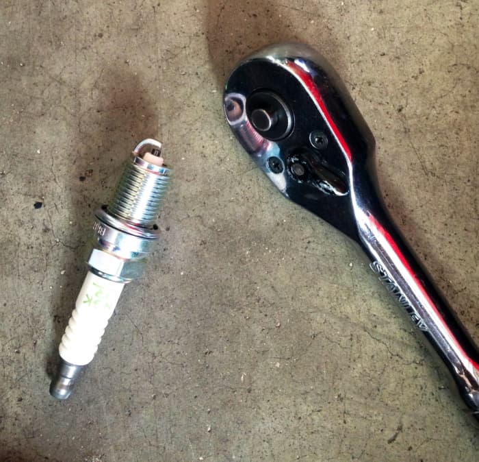 You can adjust your spark plug gap by tapping the ground electrode—gently—with your ratchet-wrench head.